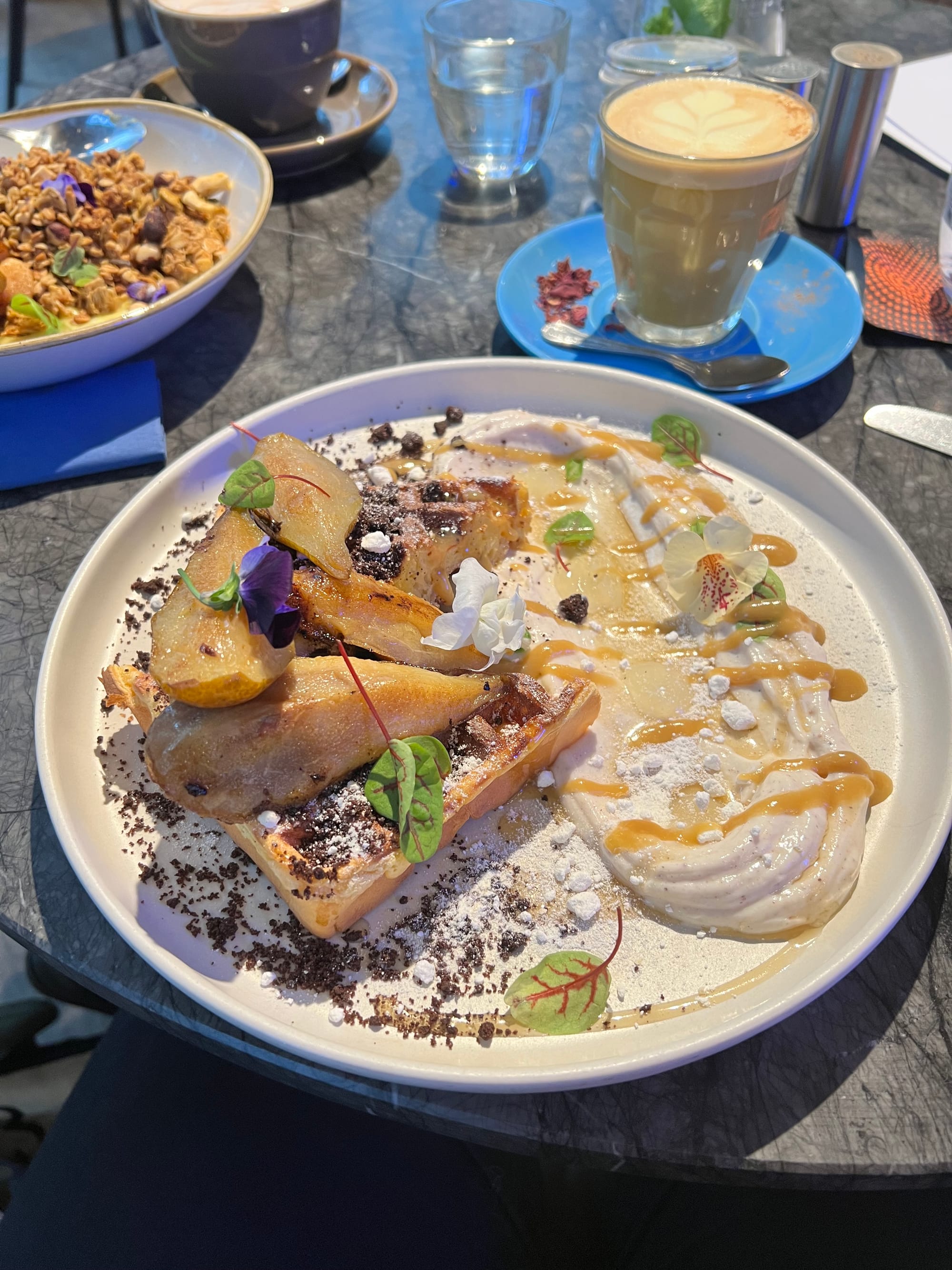 A plate with Caramelised conference pears, waffles, yellow lemon gel and toffee sauce swirled on the side from Half Cup, London.