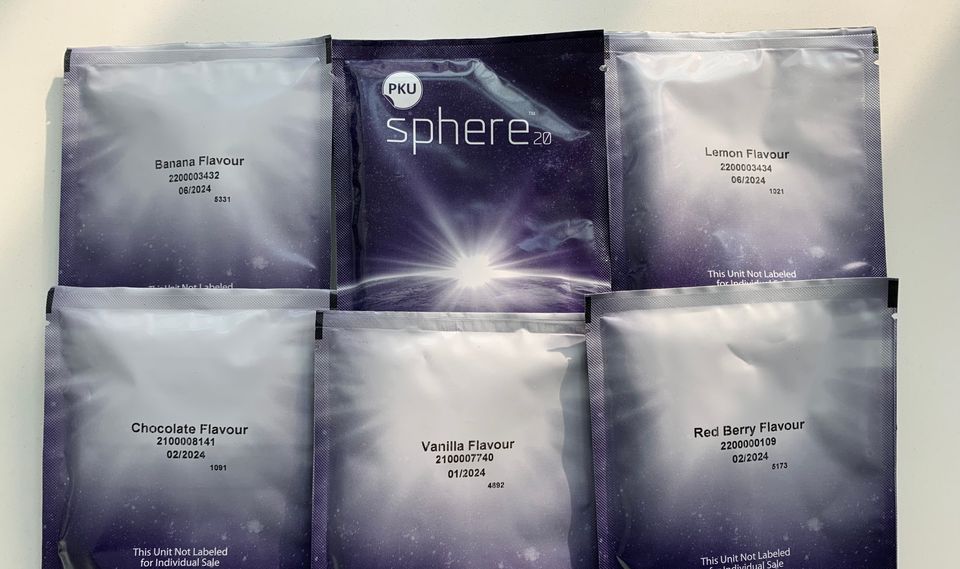 six packets of the Sphere product showing 5 Sphere flavours: Banana, Lemon, Red Berry, Vanilla, & Chocolate